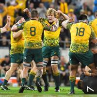Australia players celebrate after beating New Zealand in Brisbane on Oct. 21. | KYODO