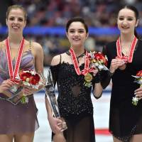 Russia\'s Evgenia Medvedeva (center), the NHK Trophy women\'s champion, poses with second-place finisher Carolina Kostner of Italy (left) and Russia\'s Polina Tsurskaya, who placed third, during an award ceremony on Saturday in Osaka. | AFP-JIJI