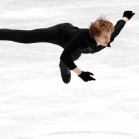 Russia\'s Sergei Voronov soars through the air in the men\'s free skate at the NHK Trophy on Saturday. Voronov captured the title with 271.12 points. | REUTERS