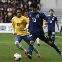 Japan\'s Hiroki Sakai controls the ball as Brazil\'s Neymar defends during their friendly on Friday in Lille, France. | AP
