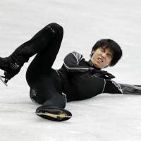Figure skater Yuzuru Hanyu grimaces after falling during a practice session, injuring his right ankle, Thursday at the NHK Trophy in Osaka. The Japan Skating Federation on Friday announced the Olympic champion\'s withdrawal from the competition. | KYODO