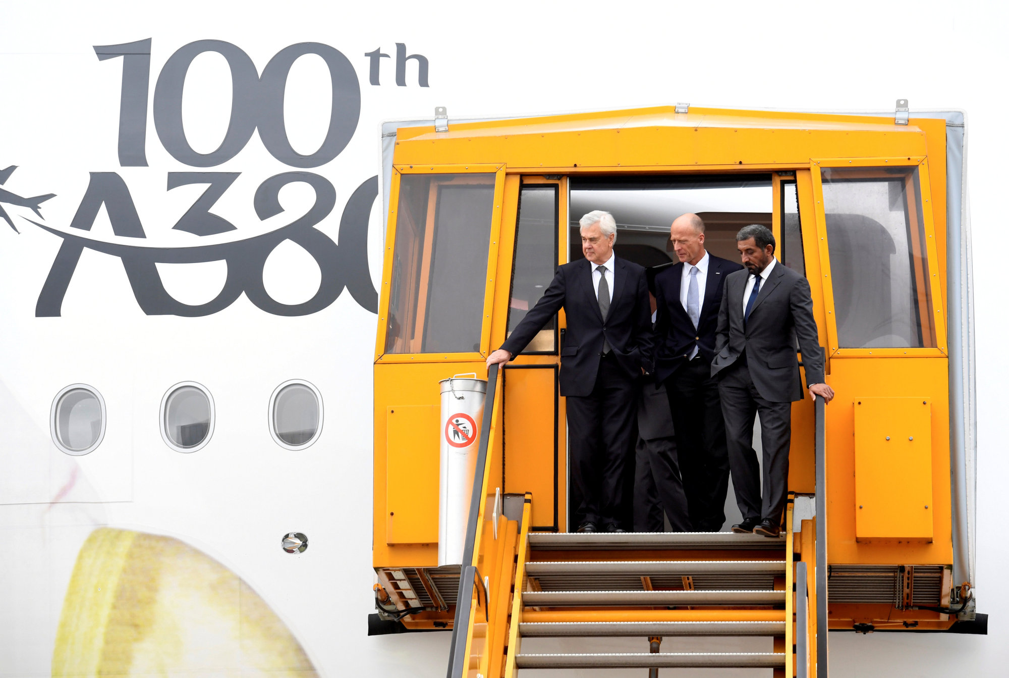 Sheikh Ahmed bin Saeed Al Maktoum, Emirates' chairman and CEO (right), Tom Enders, CEO of Airbus (left), and Tim Clark, president of Emirates Airlines, descend the steps of Airbus A380 during a delivery ceremony of Emirates' 100th Airbus A380 at the German headquarters of aircraft company Airbus in Hamburg-Finkenwerder, Nov.3. | REUTERS