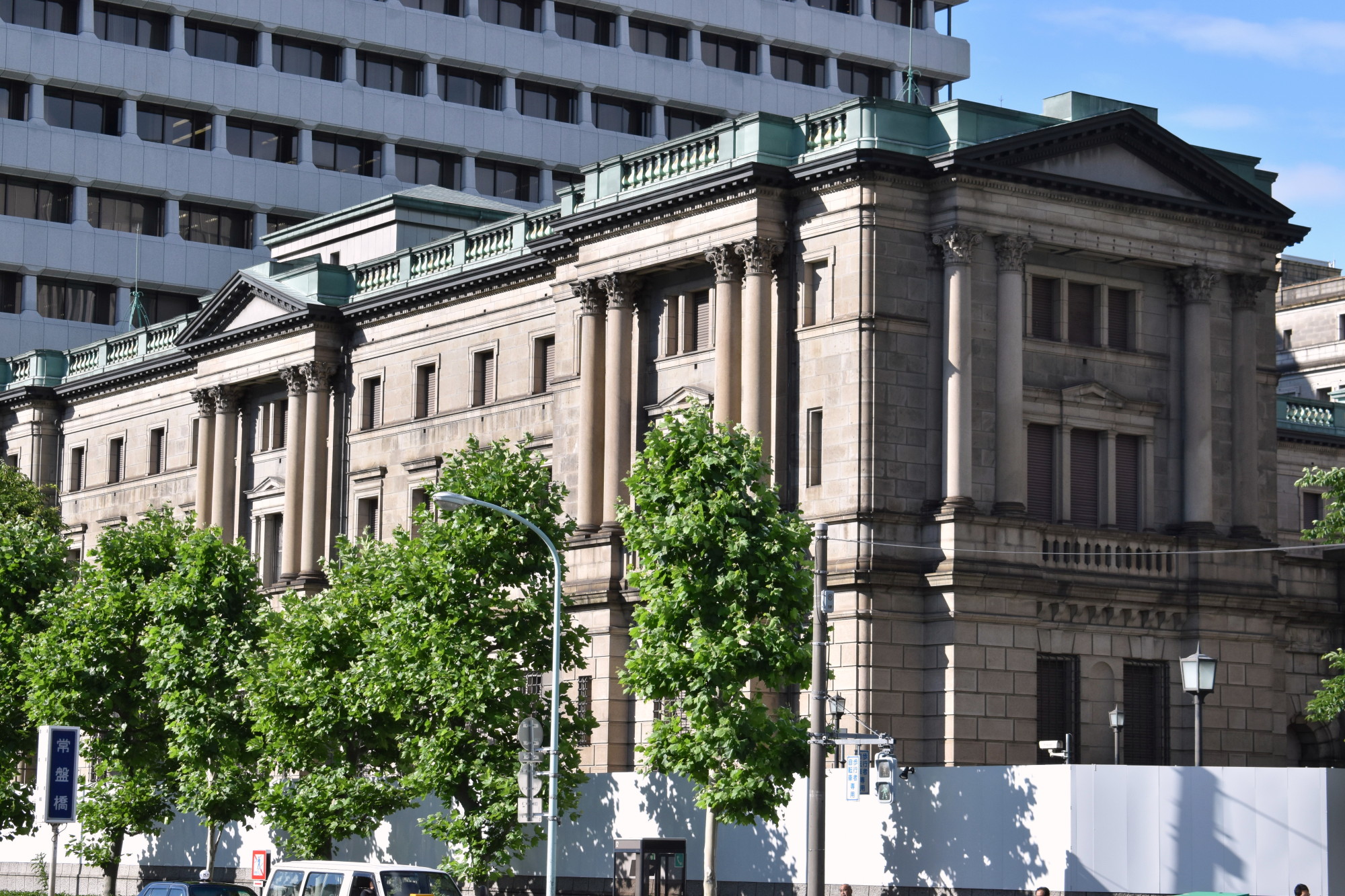 The Bank of Japan headquarters is seen in central Tokyo. The pace at which the central bank is expanding its massive hoard of bonds is expected to slow in 2018. | SATOKO KAWASAKI