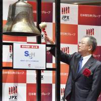 Eiichi Kuriwada, chairman of SG Holdings Co., rings the bell Wednesday during a ceremony marking the company\'s listing on the first section of the Tokyo Stock Exchange. | KYODO