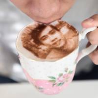 A customer drinks a \'Selfieccino\' coffee at the Tea Terrace in London Tuesday. | REUTERS