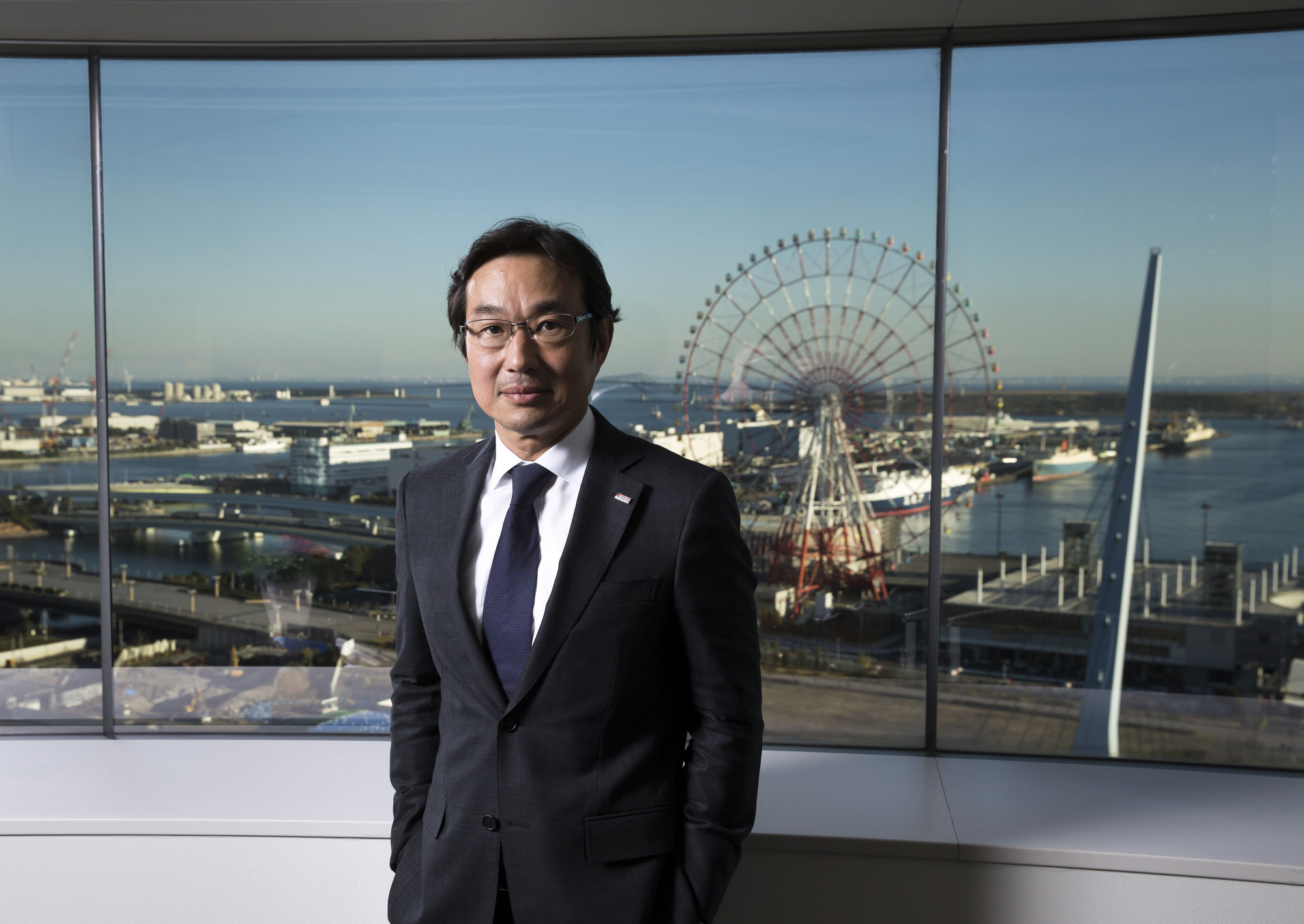 Solar Frontier CEO Atsuhiko Hirano plans to sell solar panels incorporated into roofing and wall materials, facing off with Tesla Inc. in building technology that can generate power in the smallest spaces available. | BLOOMBERG