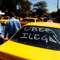 Taxi drivers take part in a demonstration against what they say is unfair competition from new car-sharing companies such as Uber in San Salvador Friday. | REUTERS