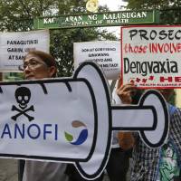 Protesters display placards during a rally outside the Department of Health as they demand accountability for government officials involved in the controversial immunization of the anti-dengue vaccine Dengvaxia to more than 700,000 Filipino children Friday in Manila. The controversial vaccine, manufactured by Sanofi Pasteur, was put on hold by the Philippines last week after new study findings showed it posed risks of severe cases in people without previous infection. The controversy has prompted the Philippine Senate to conduct an investigation. | AP