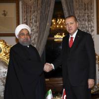 Turkish President Recep Tayyip Erdogan (right) shakes hands with Iranian President Hassan Rouhani prior to their meeting after the Organisation of Islamic Cooperation Extraordinary Summit in Istanbul, on Wednesday. | AP