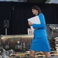 U.S. Ambassador to the U.N. Nikki Haley walks in front of recovered segments of an Iranian rocket during a press briefing at Joint Base Anacostia-Bolling Thursday in Washington. | AP