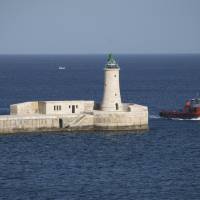 A boat passes through the entrance to the Grand Harbour in Valletta last February. | AP