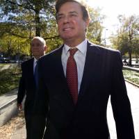 Paul Manafort accompanied by his lawyers, arrives at U.S. Federal Court in Washington Nov. 2. Prosecutors working for special counsel Robert Mueller say Manafort has been working on an op-ed with a longtime colleague \"assessed to have ties\" to a Russian intelligence service. Court papers say that Manafort and the colleague sought to publish the op-ed under someone else\'s name and intended it to influence public opinion about his work in Ukraine. | AP