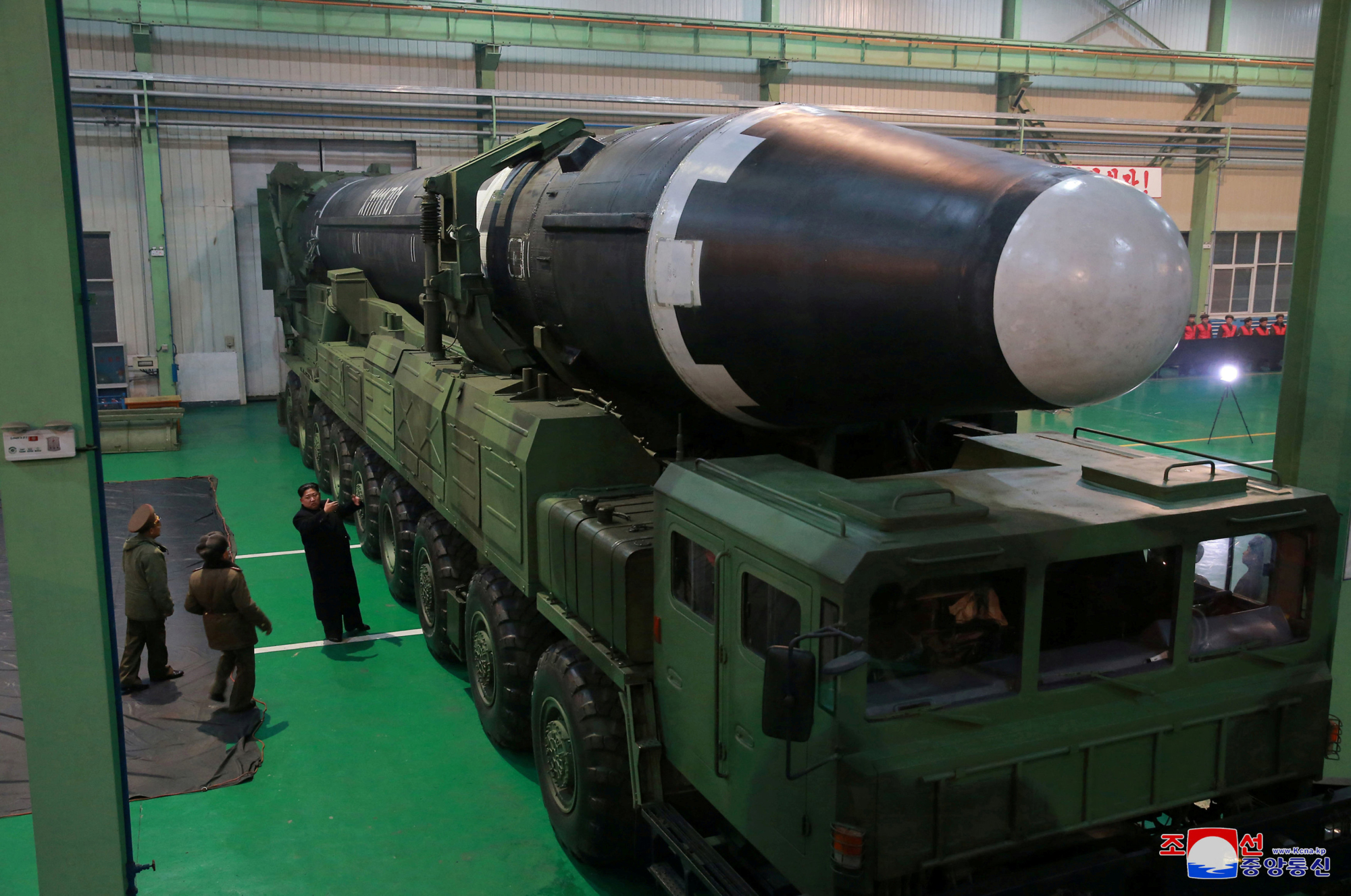 North Korean leader Kim Jong Un is seen next to a newly developed Hwasong-15 intercontinental ballistic missile in this undated photo released Thursday. | REUTERS