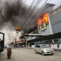A shopping mall burns in Davao City on the southern Philippine island of Mindanao on Saturday. | AFP-JIJI