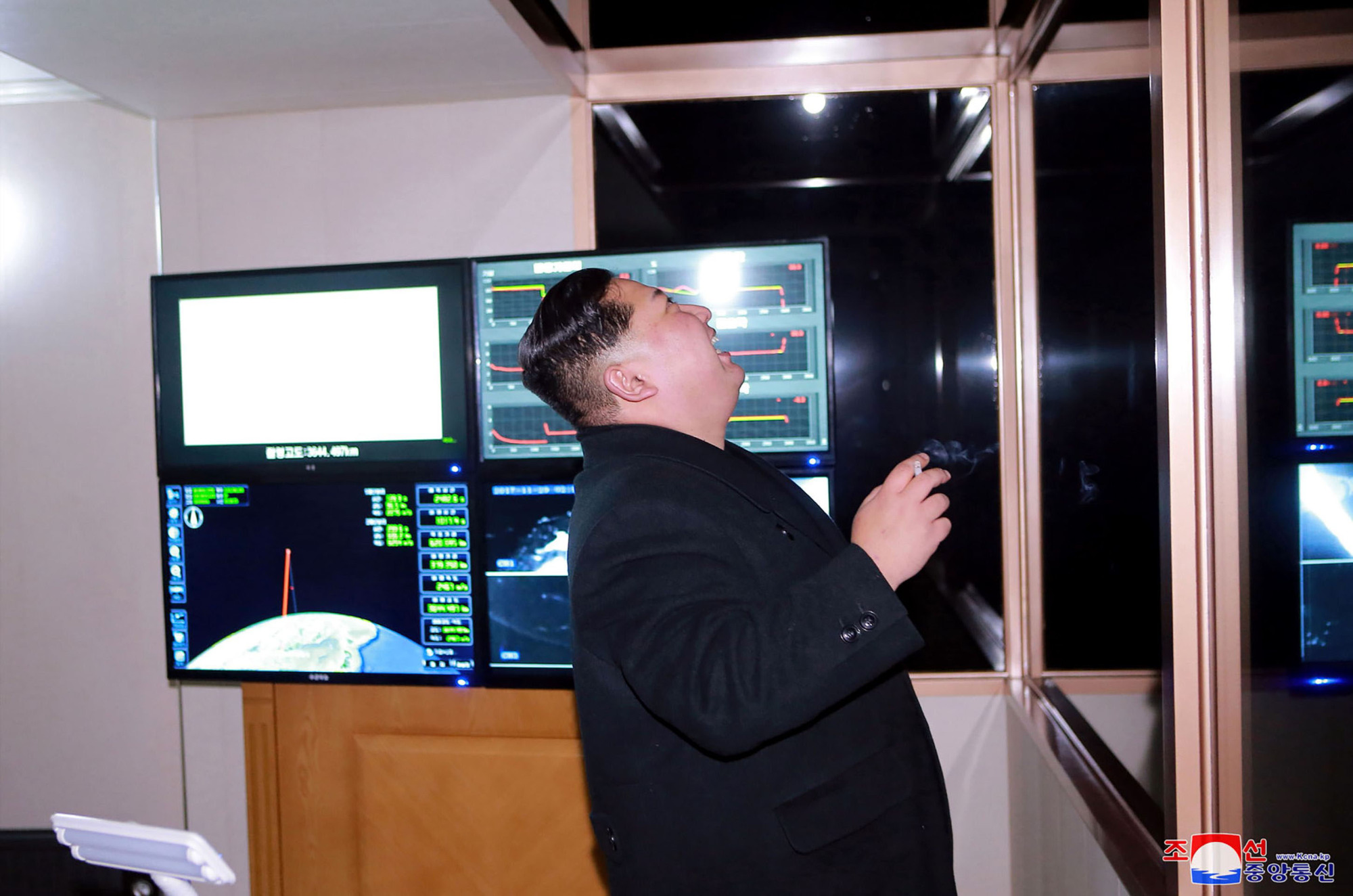 North Korean leader Kim Jong Un watches Wednesday's missile launch on a screen. | AFP-JIJI