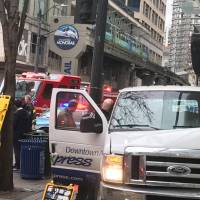 This photo provided by the Seattle Fire Department shows the scene of a van crash in Seattle on Thursday. Authorities say a few people were sent to hospitals after the van left the street and hit a building. | SEATTLE FIRE DEPARTMENT / VIA AP