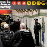 A New York City Police (NYPD) officer stands in the subway corridor at the New York Port Authority subway station near the site of an attempted detonation the day before in New York City Tuesday. | REUTERS