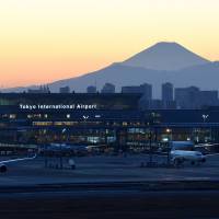 Mount Fuji serves as a backdrop for the international terminal at Tokyo\'s Haneda airport on Dec. 5 | SATOKO KAWASAKI