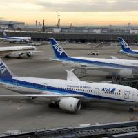 Aircraft are seen parked at Haneda airport near the heart of Tokyo on Dec. 15. | SATOKO KAWASAKI