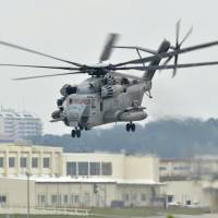 A CH-53E transport helicopter flies at the U.S. Marine Corps Air Station Futenma in Ginowan, Okinawa Prefecture, on Tuesday. | KYODO