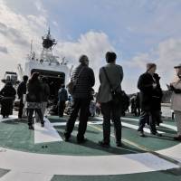 A cold day on the deck of the Japan Coast Guard cutter Daisen, as members of the general public enjoy a rare tour of the ship. | AARON BERMAN