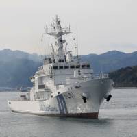 Japan Coast Guard members demonstrate their climbing skills. | AARON BERMAN