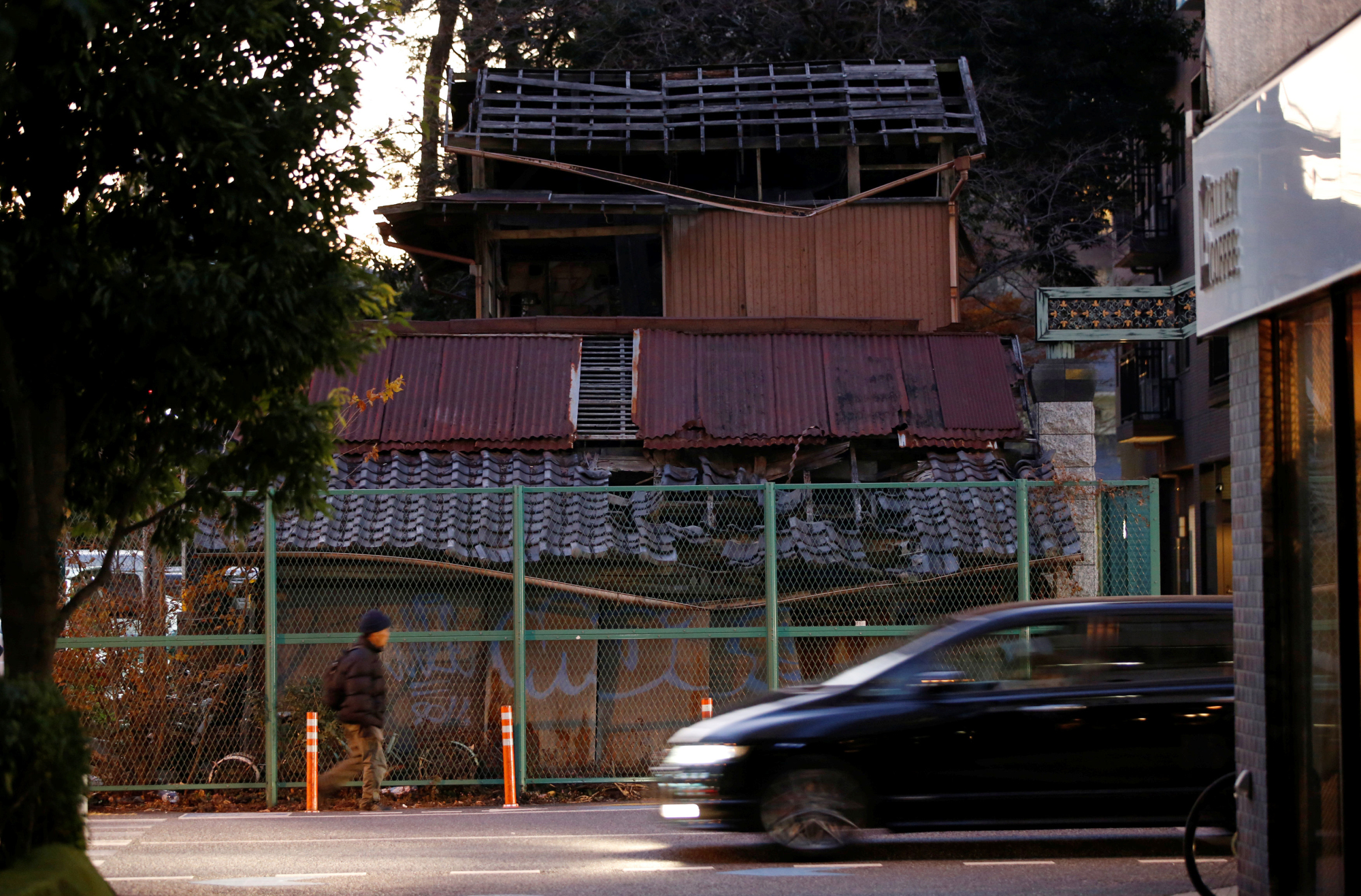 Unoccupied homes are permeating suburbs and worming into crowded cities at an alarming rate. This house in Omiya Ward, Saitama, has blocked construction of a new street. | REUTERS