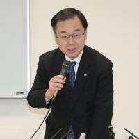 Yoshihiro Kizawa, an Osaka University trustee, faces reporters Tuesday to explain the cyberattacks that led to the university\'s massive personal data leak. | KYODO