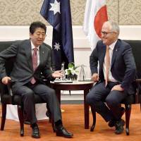 Prime Minister Shinzo Abe (left) and Australian counterpart Malcolm Turnbull hold bilateral talks in Manila on Nov. 13. | KYODO