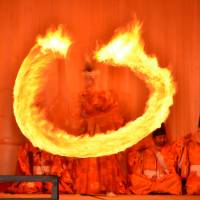 Lit up: A priest performs the Dance of Fire at the Akiha Fire Ceremony in Hamamatsu. | AP