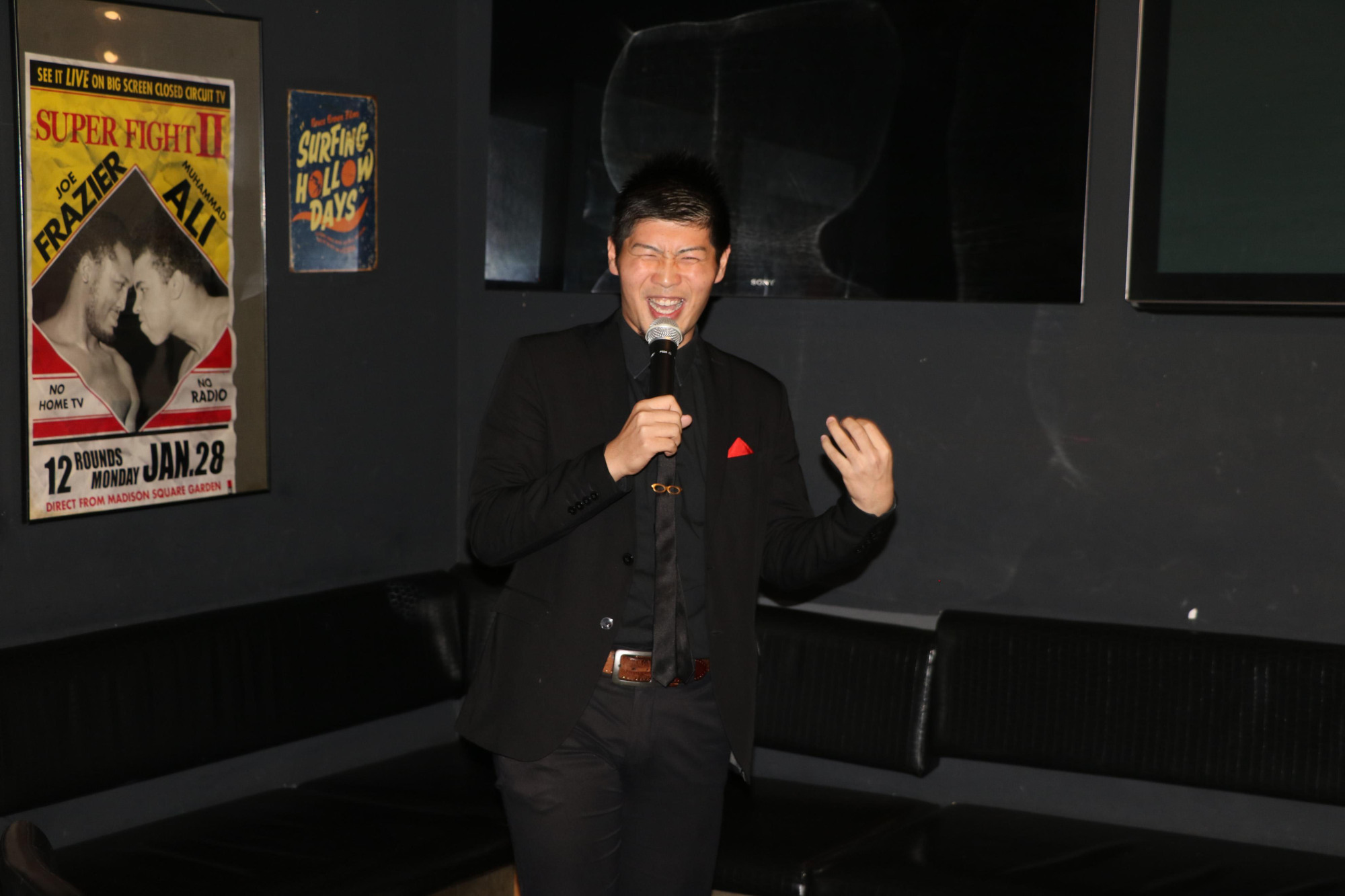 Proper punchlines: Stand-up comedian Saku Yanagawa shows off for the camera during a gig at Tokyo Sports Cafe last month. Based in Tokyo and Chicago, Yanagawa is aiming to become the first Japanese regular on U.S. TV show 'Saturday Night Live.' | KYODO