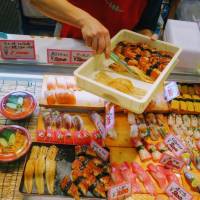 Fresh fish: A vendor restocks a display of sushi at Karato Market in Shimonoseki, Yamaguchi Prefecture. | LILY CROSSLEY-BAXTER