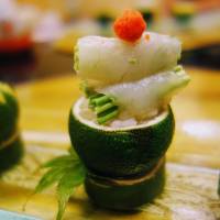 Subtle flavor: Fugu (puffer fish) sashimi served on fresh yuzu citron at Yamaguchi Hotel. | LILY CROSSLEY-BAXTER