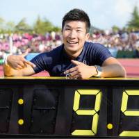 Fast feet: Yoshihide Kiryu points to his record-breaking time after finishing the 100-meter race at a meet in Fukui Prefecture in September. | KYODO