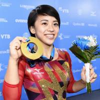 Top spot: Mai Murakami shows off her gymnastics gold in Montreal in October. | KYODO