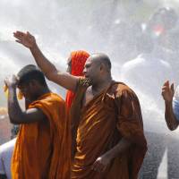 Police in Sri Lanka use water cannon to disperse people protesting a government plan to grant a 99-year lease of Hambantota port to a Chinese company on Jan. 7. Nations caught in debt bondage to China risk losing both their most valuable natural assets and their very sovereignty. | AP