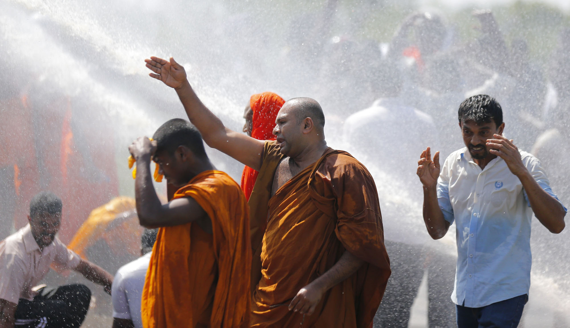 Police in Sri Lanka use water cannon to disperse people protesting a government plan to grant a 99-year lease of Hambantota port to a Chinese company on Jan. 7. Nations caught in debt bondage to China risk losing both their most valuable natural assets and their very sovereignty. | AP