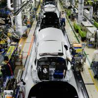 Workers assemble Prius cars at a Toyota Motor Corp. plant  in Aichi Prefecture on Dec. 8. Like other advanced economies, the importance of manufacturing in Japan\'s economy declined in the past two decades, but it stabilized in recent years and has even picked up a bit. | BLOOMBERG