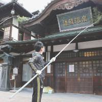 Winter cleaning: Volunteers clean the exterior of Dogo Onsen Honkan in Matsuyama, Ehime Prefecture. | KYODO