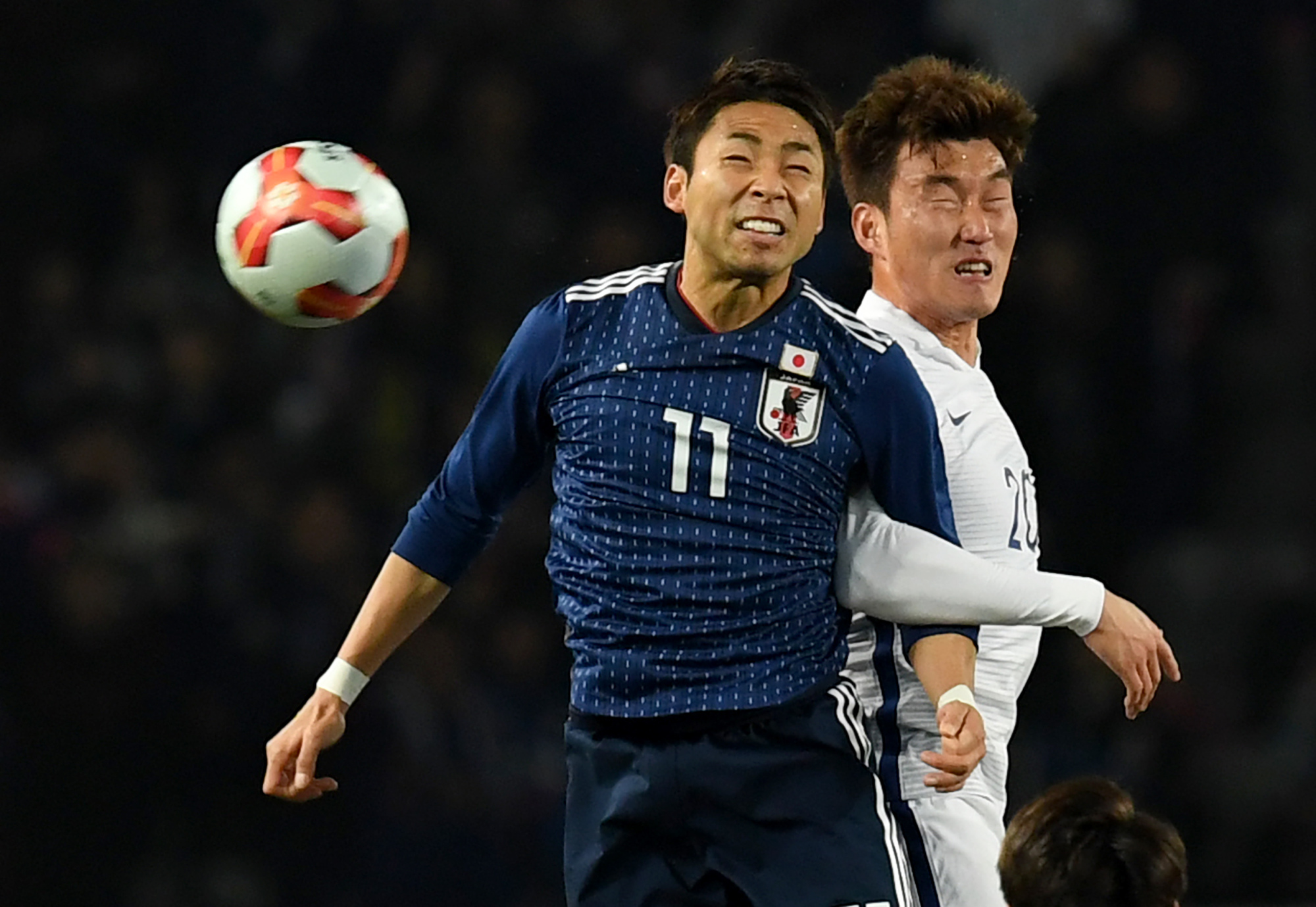 Japan's Yu Kobayashi (front) and South Korea's Jang Hyun-soo vie for the ball during the final match of the E-1 Football Championship on Saturday at Ajinomoto Stadium. | AFP-JIJI