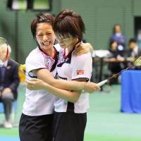 Yuki Fukushima (left) and Sayaka Hirota celebrate after beating Misaki Matsutomo and Ayaka Takahashi in the women\'s doubles final at the national championships on Sunday. | KYODO