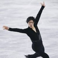Keiji Tanaka skates to \"Memories\" in the men\'s short program on Friday. He is in second place with 91.34 points. | KYODO
