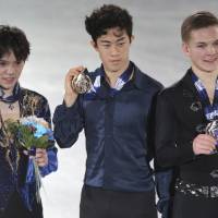 Winner Nathan Chen (center), runner-up Shoma Uno and third-place finisher Mikhail Kolyada are seen on the podium after the men\'s free skate at the Grand Prix Final. | AP