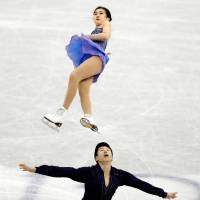 China\'s Gao Yumeng (top) and Xie Zhong are seen in action in the juniors pairs free skate at the Junior Grand Prix Final on Friday. | REUTERS
