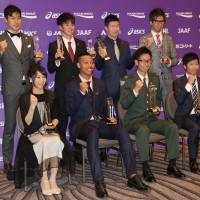 Yoshihide Kiryu (second from the right in the back row), Abdul Hakim Sani Brown (second from the left in the front row) and other award recipients pose for photos at the JAAF Athletics Award 2017 event in Tokyo on Tuesday. | KAZ NAGATSUKA
