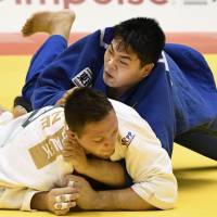 Yusei Ogawa (top) takes on Lukas Krpalek of the Czech Republic during the men\'s over-100-kg final at Grand Slam Tokyo on Sunday. | KYODO