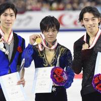 All-Japan Championship runner-up Keiji Tanaka (left), winner Shoma Uno (center) and third-place finisher Takahito Mura display their medals after Sunday\'s free skate. | KYODO