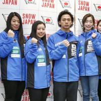 Ayumu Hirano (center) and Tomoka Takeuchi (far right) pose with fellow members of the Japan Olympic snowboarding team at an event in Tokyo on Friday. | KYODO