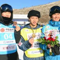 Winner Ayumu Hirano (center), runner-up Raibu Katayama (right) and third-place finisher Yuto Totsuka are seen after a snowboard World Cup  men\'s halfpipe event on Thursday in Zhangjiakou, China. | KYODO