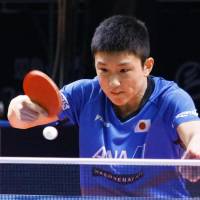 Tomokazu Harimoto hits a shot to Germany\'s Dimitrij Ovtcharov in the quarterfinals of the ITTF World Tour Grand Finals on Saturday. Ovtcharov won 4-3. | KYODO